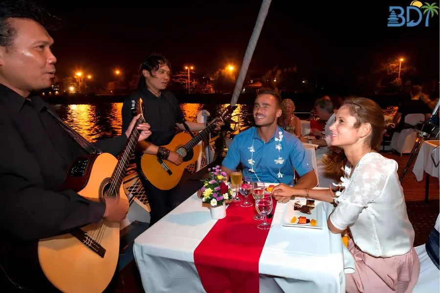 Savor a sophisticated 5-course dinner and live music aboard a luxury 64-foot sailing catamaran around Benoa Harbour.